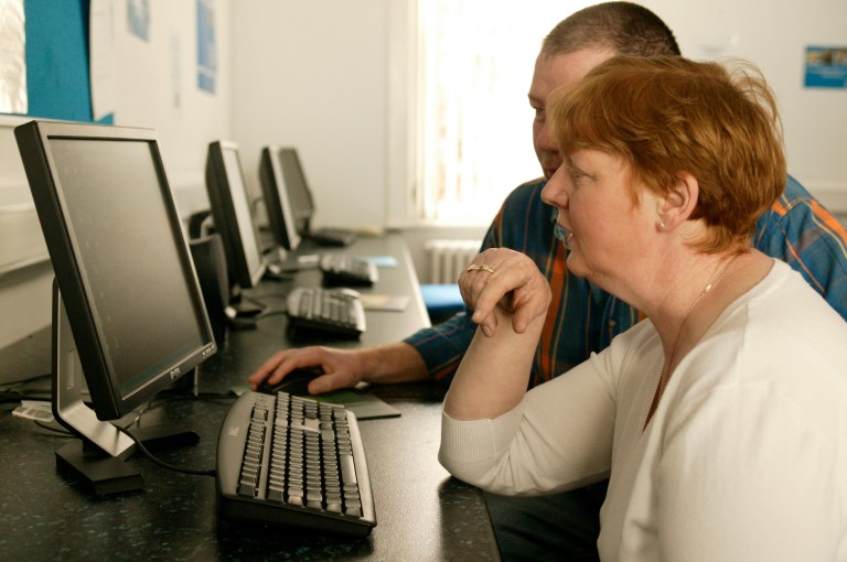 2 Adult learners in front of a Desktop monitor