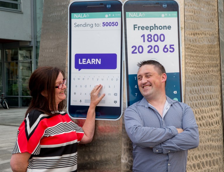 A man and a woman at the National College of Ireland square promoting NALA Services