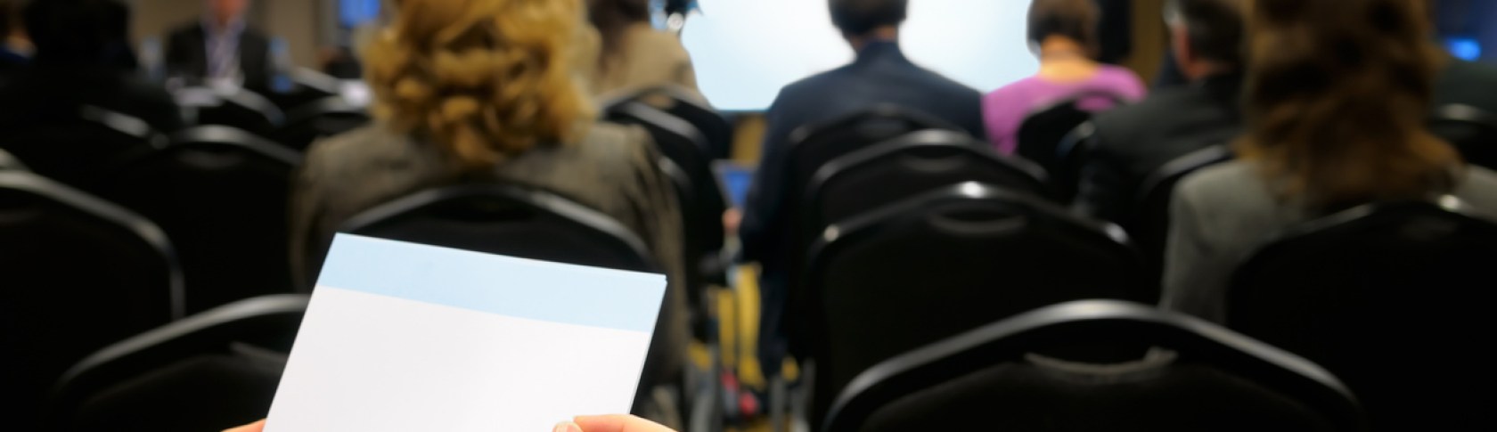 Notebook in women's hands against the background of the business room