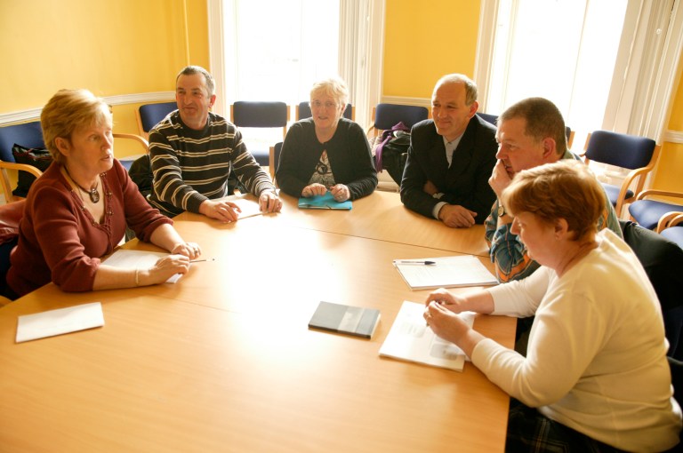 People sitting around a table. Stock image