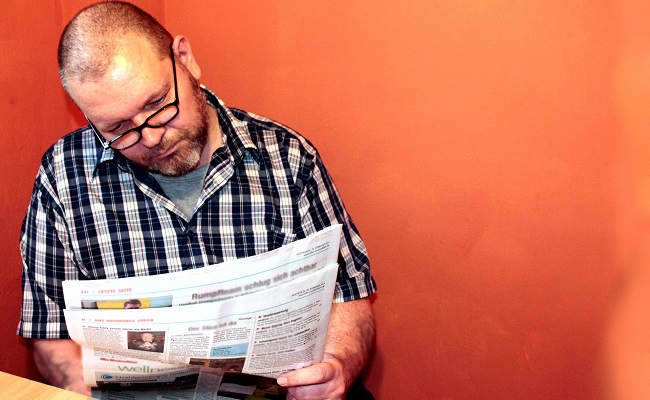 A man reading a newspaper (stock photo)