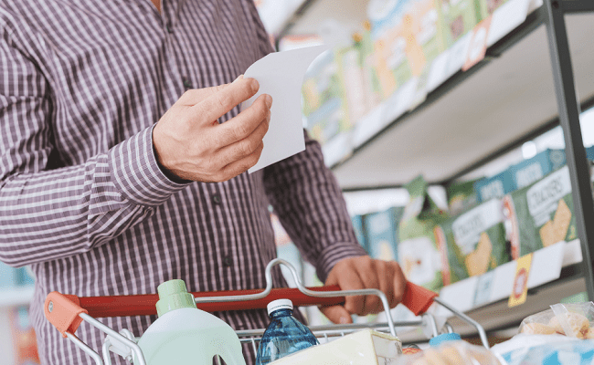 a customer is checking the shopping list at a grocery store